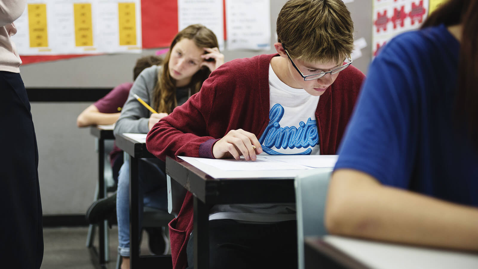 students focused on exam in high school classroom