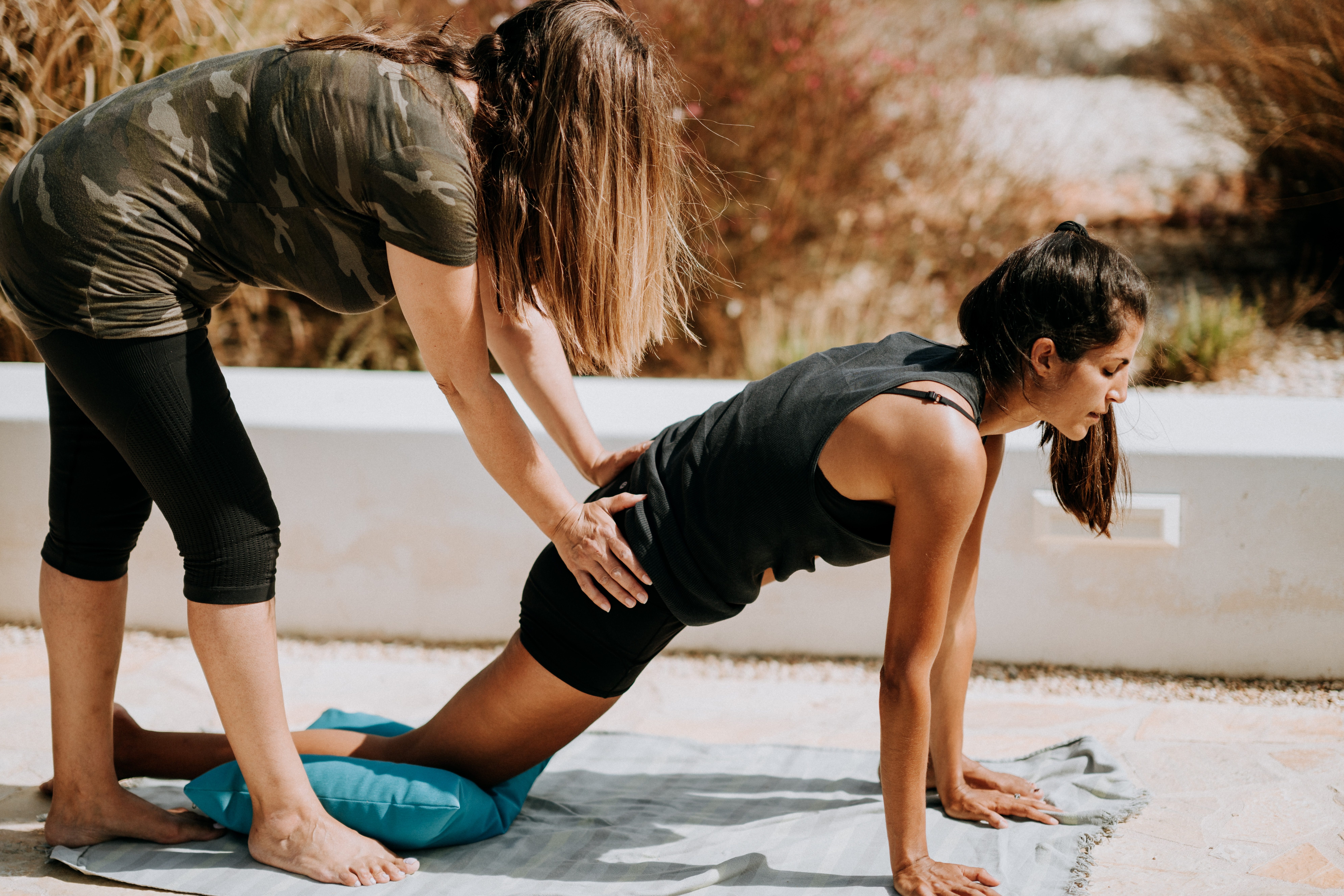 a physical therapist helps a woman with a modified plank