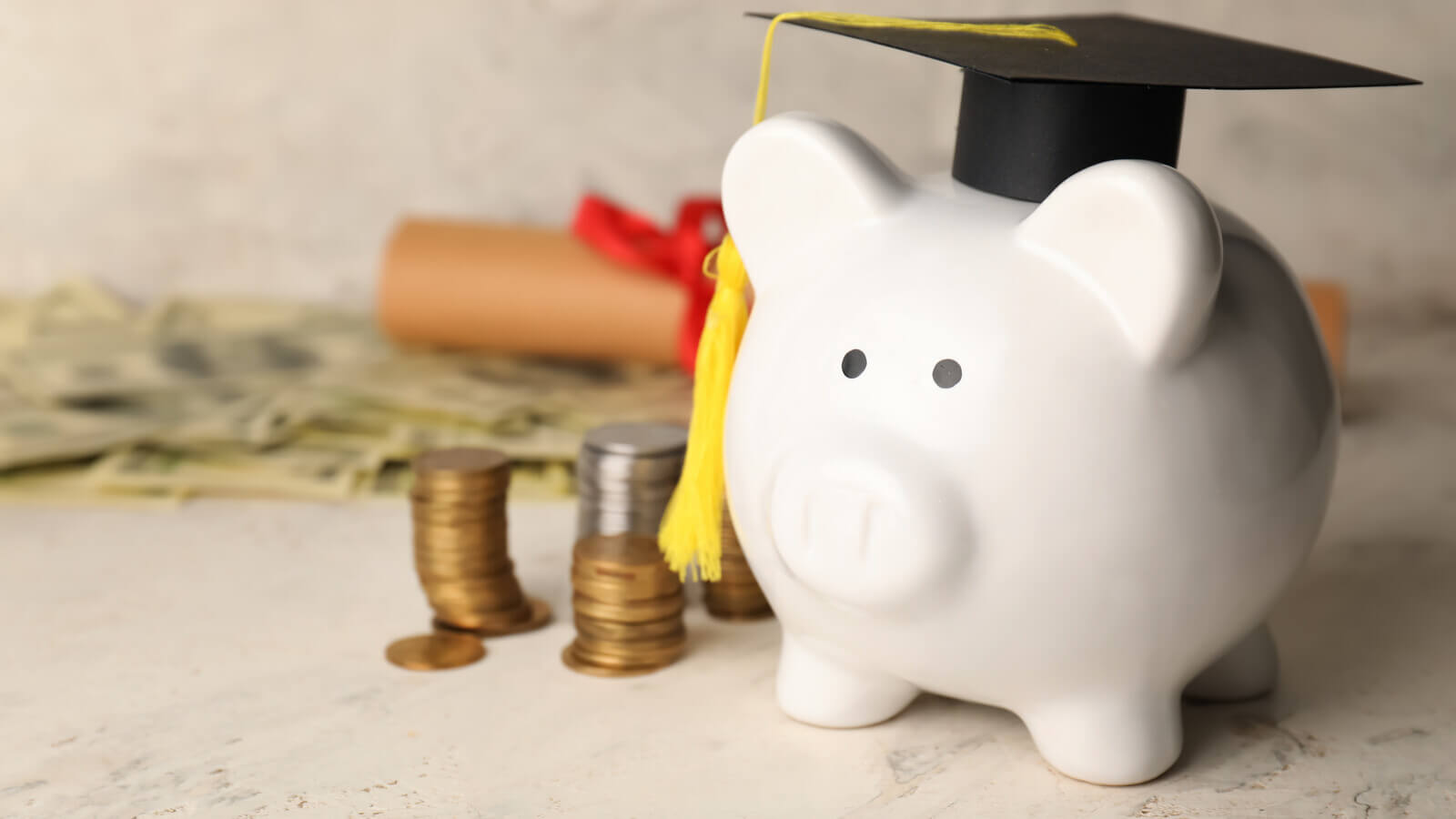 Piggy bank wearing a collegiate graduation cap