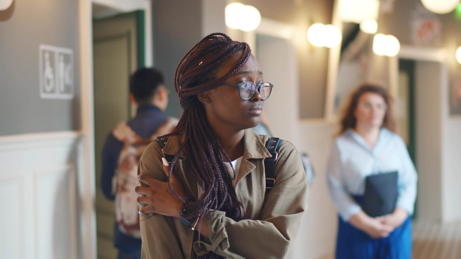Anxious student stands in a hallway