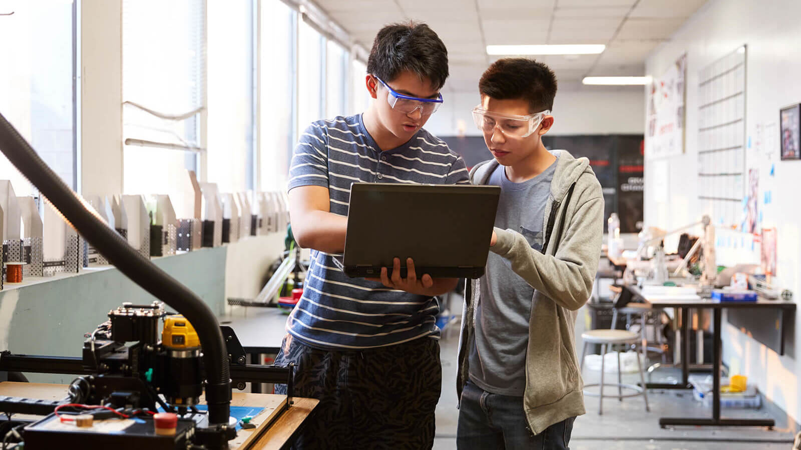 two students study engineering in a lab