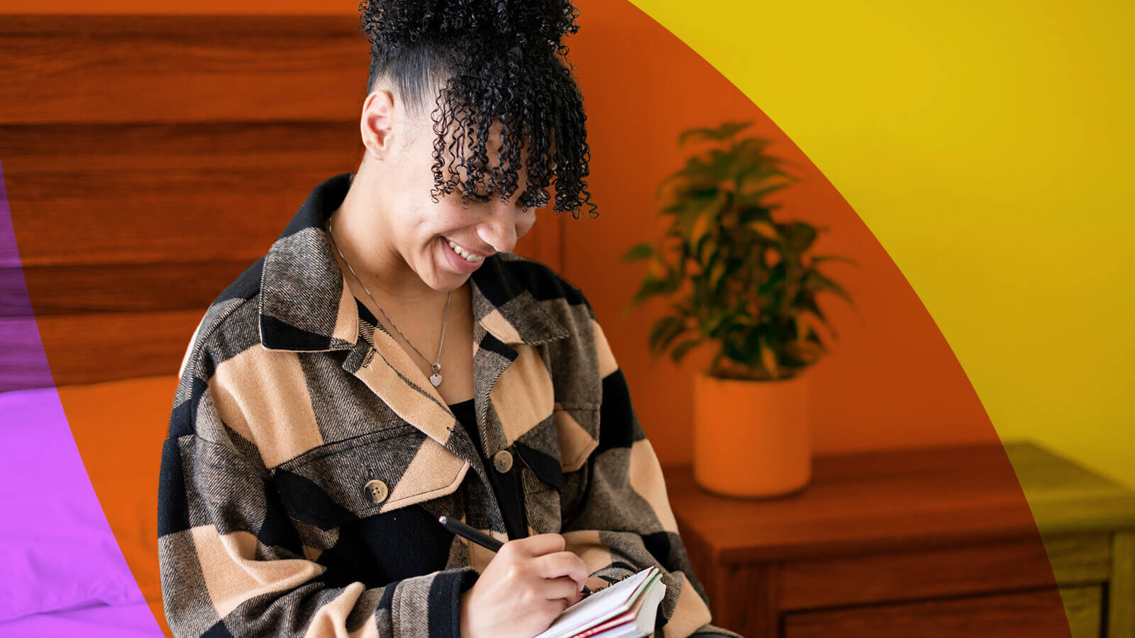 a student writes in a notebook, excited about her senior year of high school