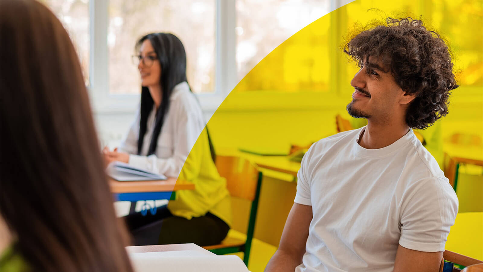two high school seniors participate in class