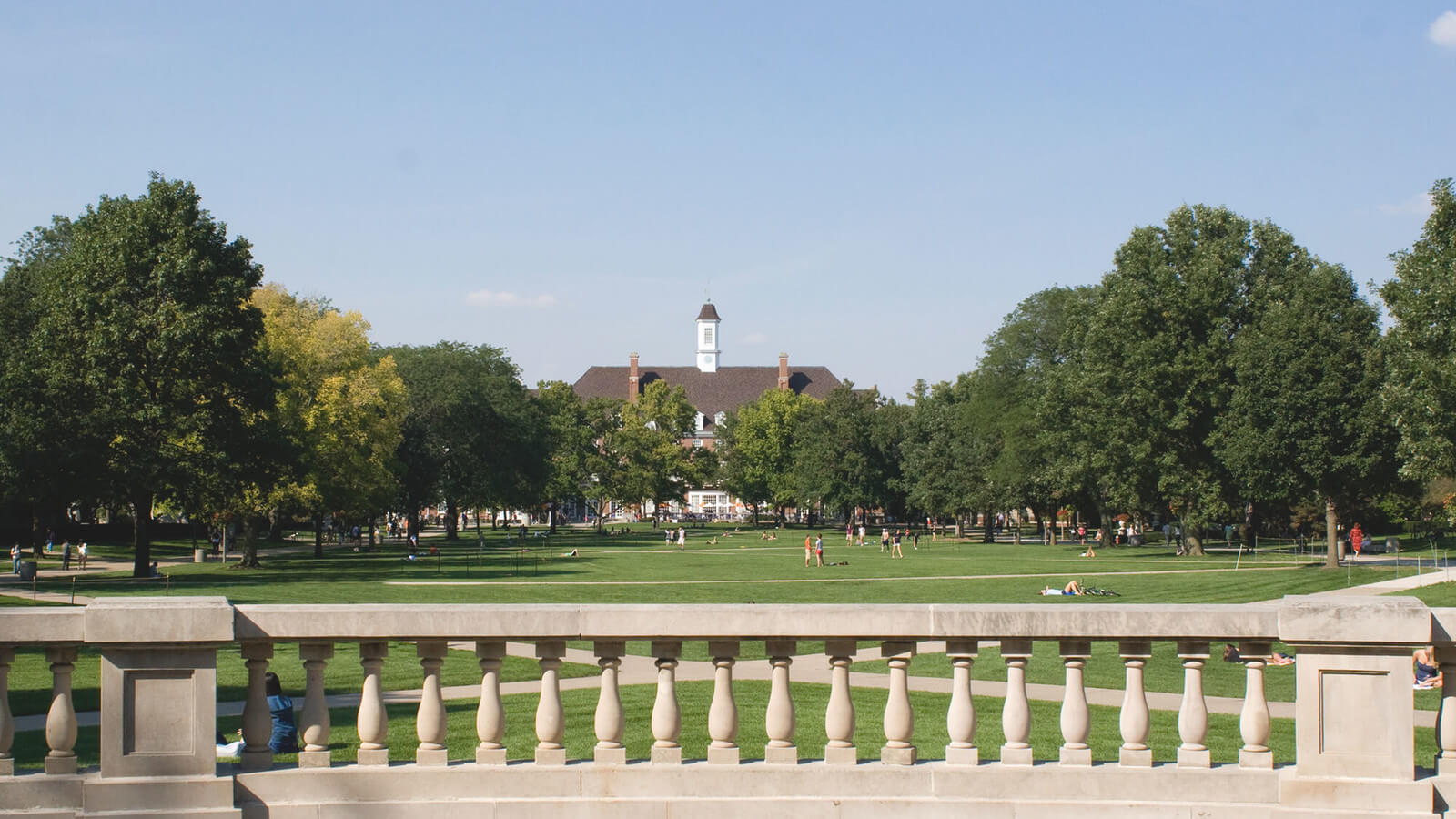 A college campus with wide grassy lawn
