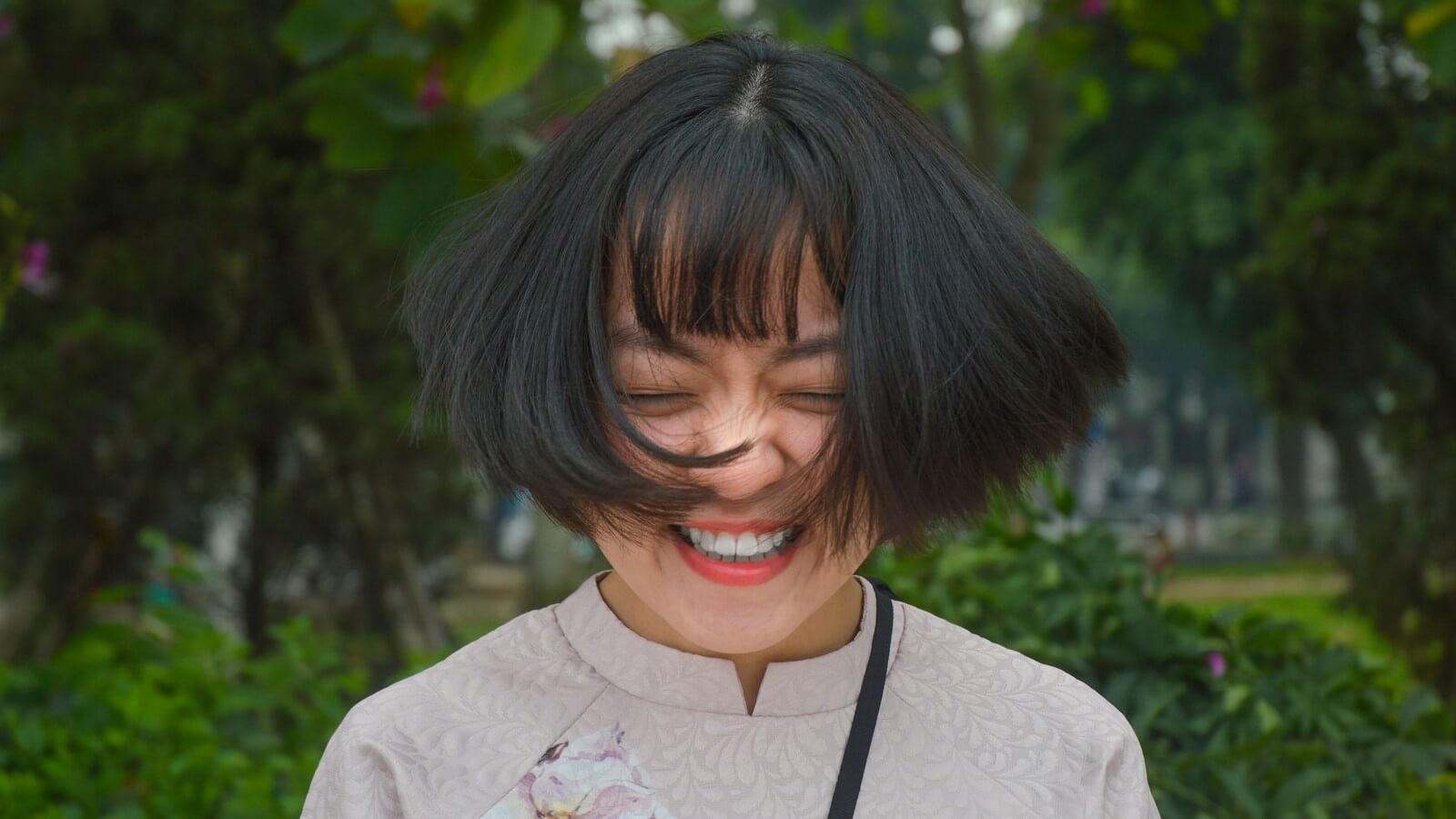 Woman with short hair shaking her head with a smile. 
