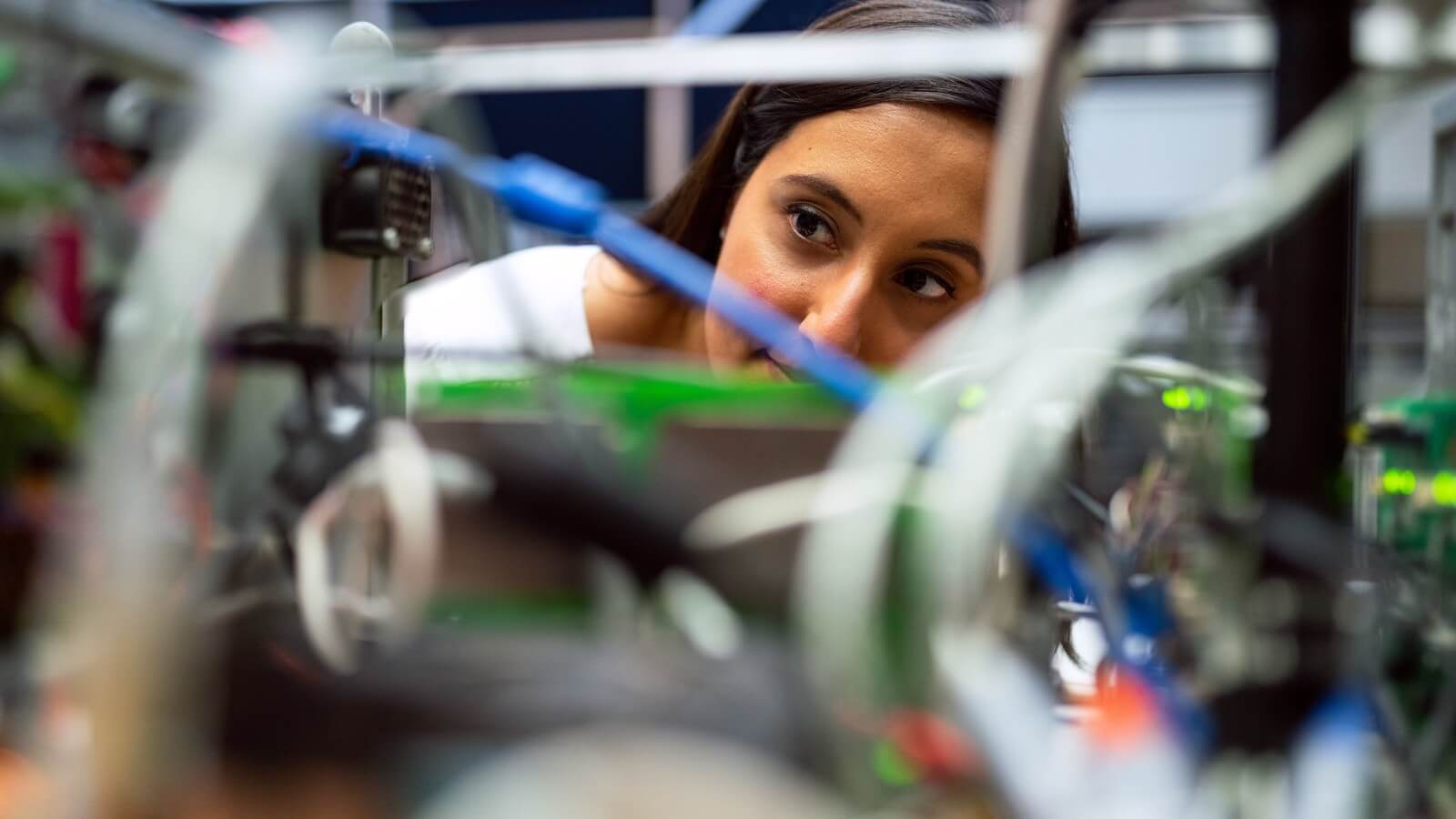 a female student works on an engineering project in a trade school