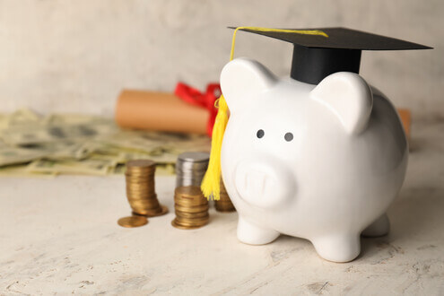 Piggy bank wearing a collegiate graduation cap