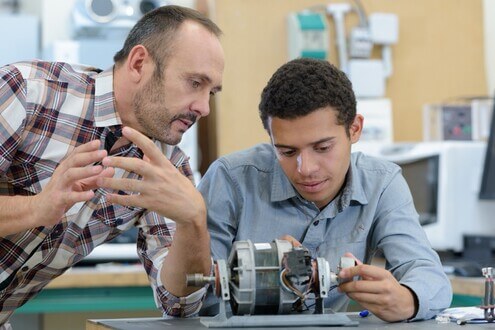 College engineering student works on a project with their professor