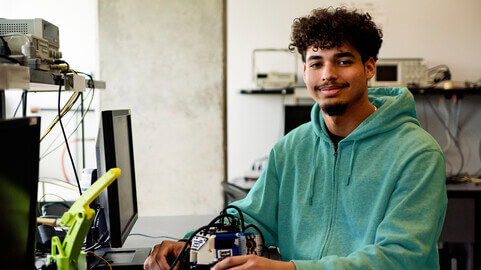 a student puts together a model in an architecture program