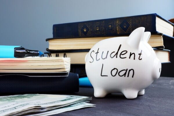 Image of stacks of books, money and a piggy bank that says "Student Loan"