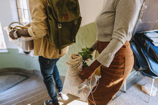 two people moving containers with personal belongings