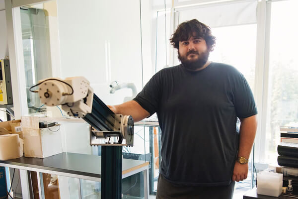 a man stands in front of a heavy machine