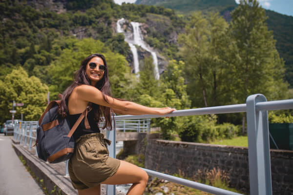 a woman stands on a bridge 