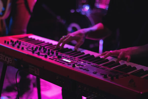 a man plays a keyboard on stage at a music show