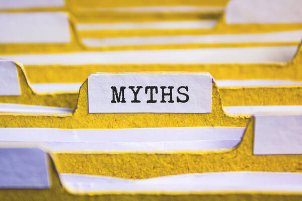a stack of yellow file folders with one labeled myths