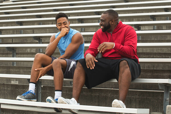 A high school student and mentor laughing.