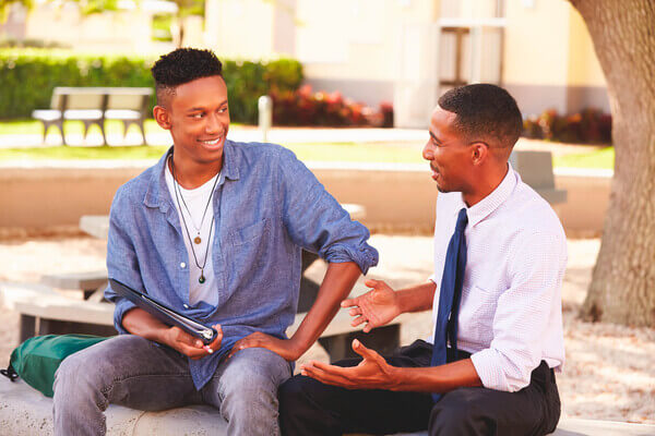 Two professionals chatting with smiles on their faces