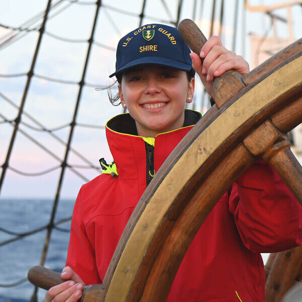 Coast Guard servicewoman at the wheel of a ship