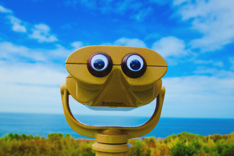 eyes looking through a viewer with the ocera in the background