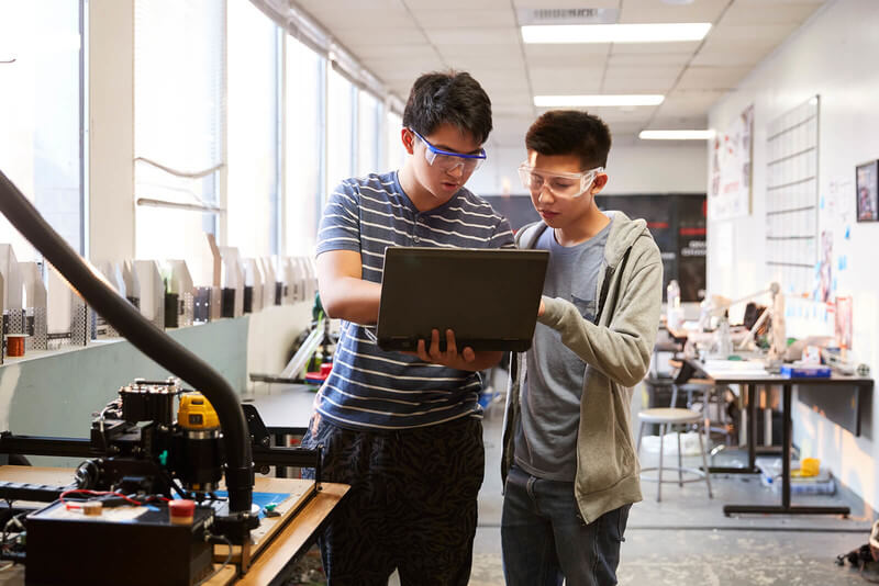 two students study engineering in a lab