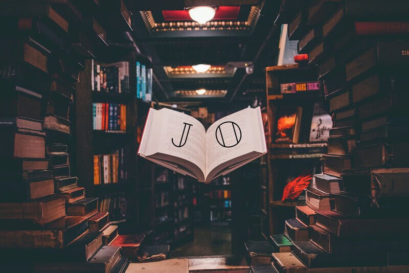 A circular book shelf with a suspended open book displaying the letters J and O.
