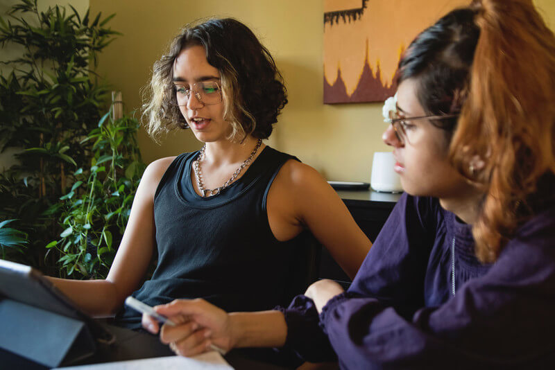 two students looking at information on a tablet