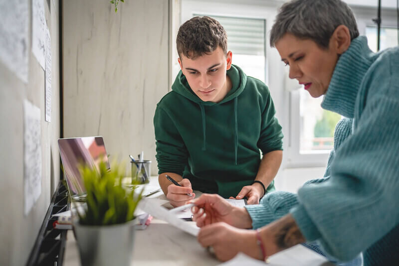 A male student getting information from a female guardian.