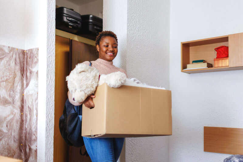 a young woman moving into her dorm