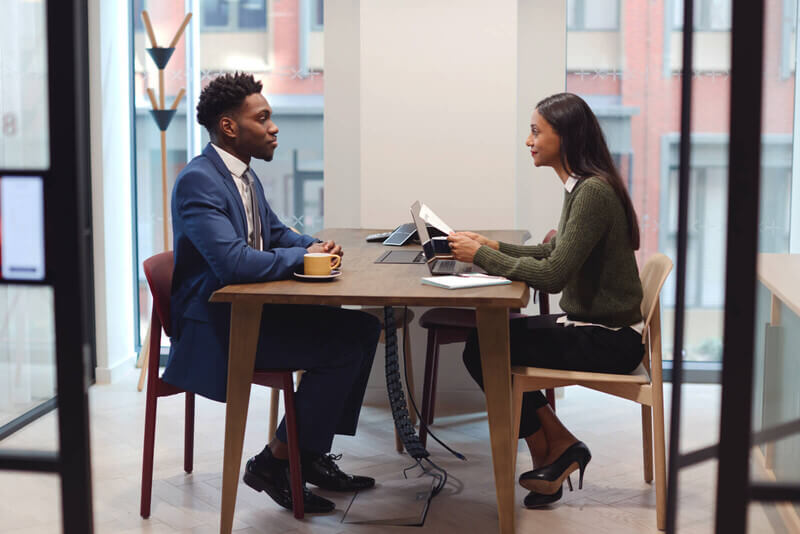 a student wears a suit and participates in a college interview