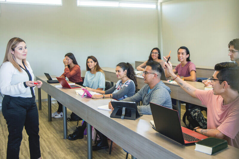 a community college classroom with an instructor at the front of the room