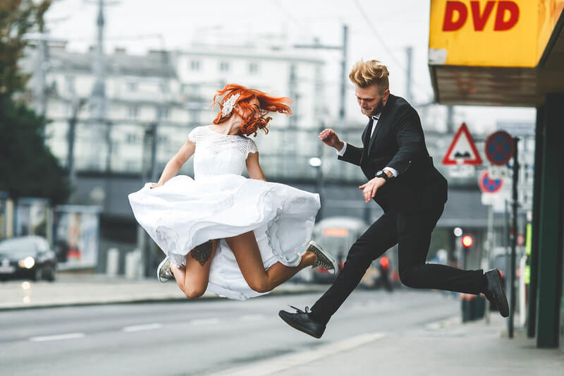 a couple dressed for a wedding dances in the street