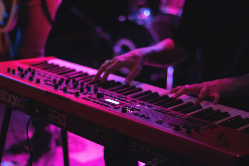 a man plays a keyboard on stage at a music show