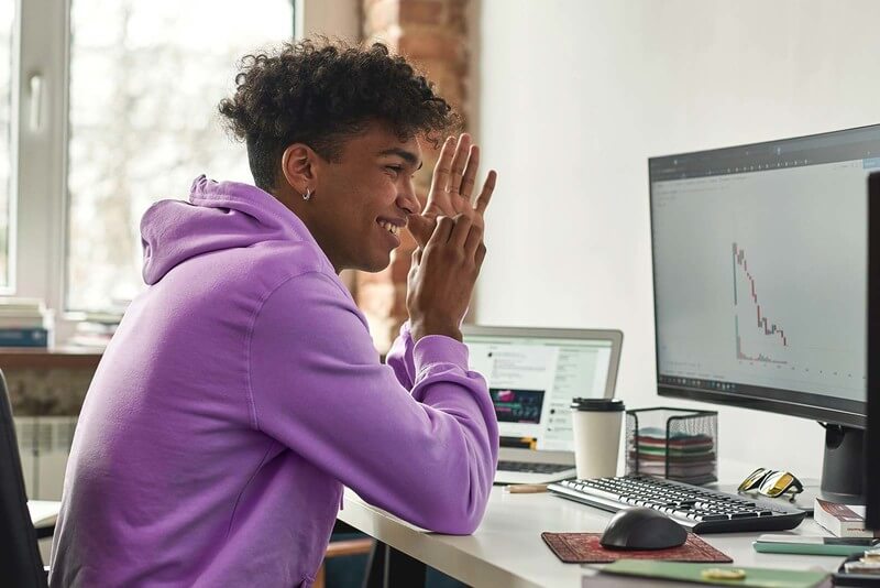 a student looks at his computer while taking an online college class