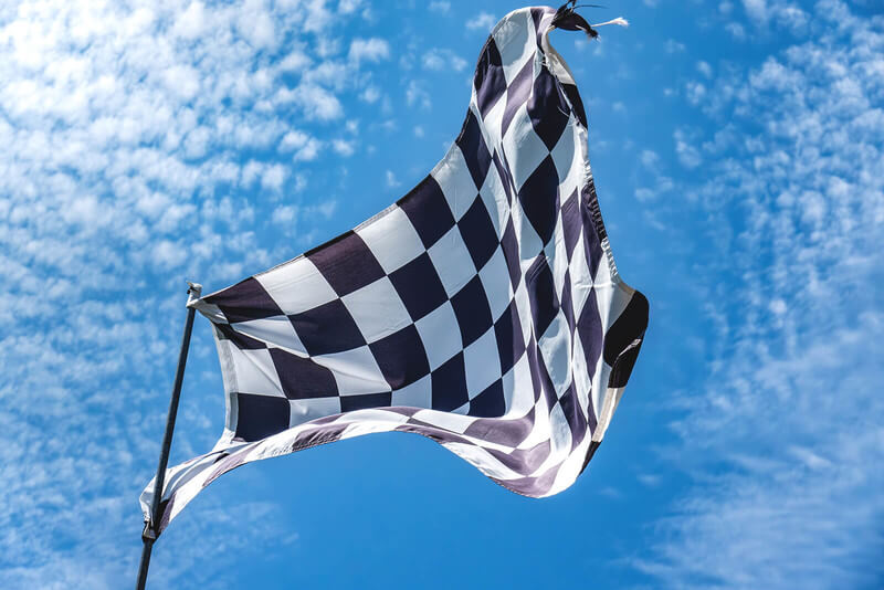 a finish line checkered flag blowing in the air