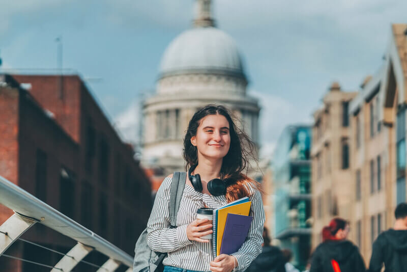 a young woman walks through a European town