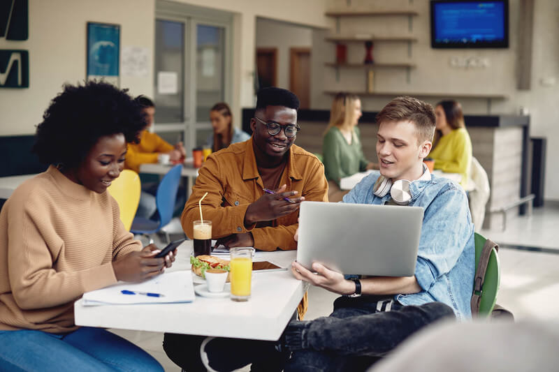 three college students in a common area studying