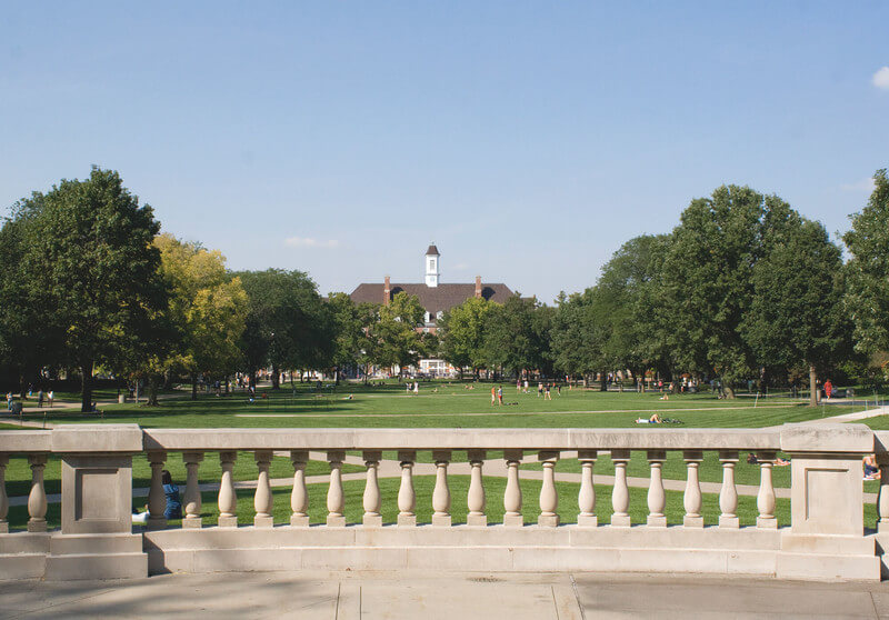A college campus with wide grassy lawn