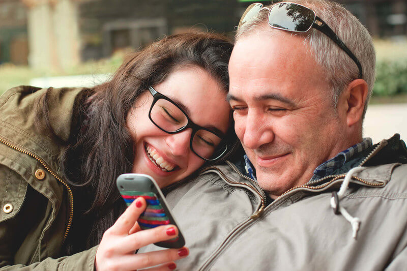 a dad and daughter celebrate her college admission news