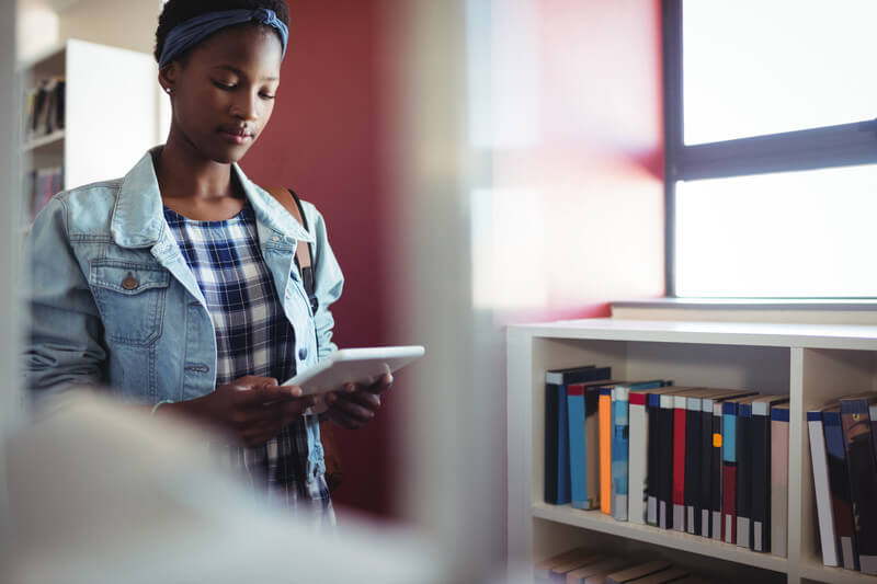 College student doing research in a library